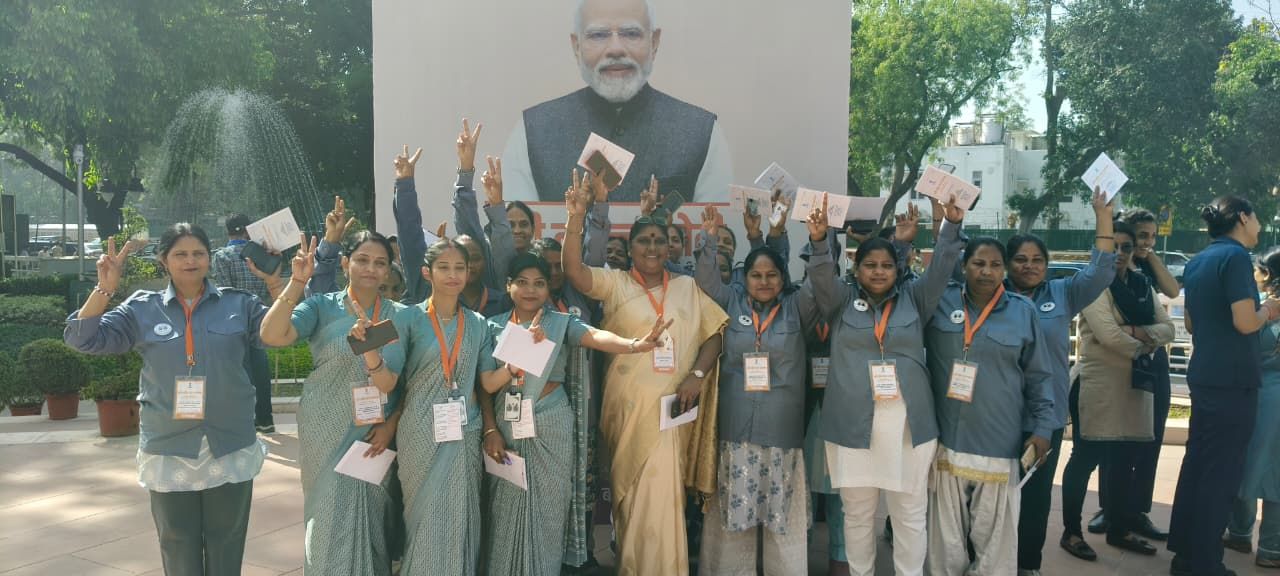 Women members of Naari Shakti raising their hands together
